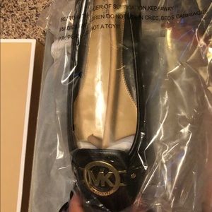 Never worn Michael Kors Flats. Size 10.